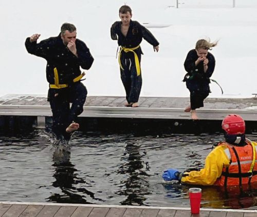 Karate club members leap into the icy depths during the Heritage Festival Polar Plunge.